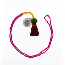 Load image into Gallery viewer, Colorful Old Fashioned Online beads with tassel, pompom and silver amulet charm necklace in pink and blue on flat lay
