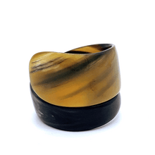 Load image into Gallery viewer, A gif animation of large dark coloured  Old Fashioned Online Wide Minimalist polished black white and mushroom spiral Cuff bangle, made from ethically sourced natural horn
