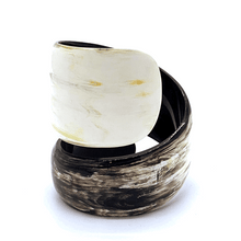 Load image into Gallery viewer, A gif animation of large light coloured  Old Fashioned Online Wide Minimalist polished black white and mushroom spiral Cuff bangle, made from ethically sourced natural horn

