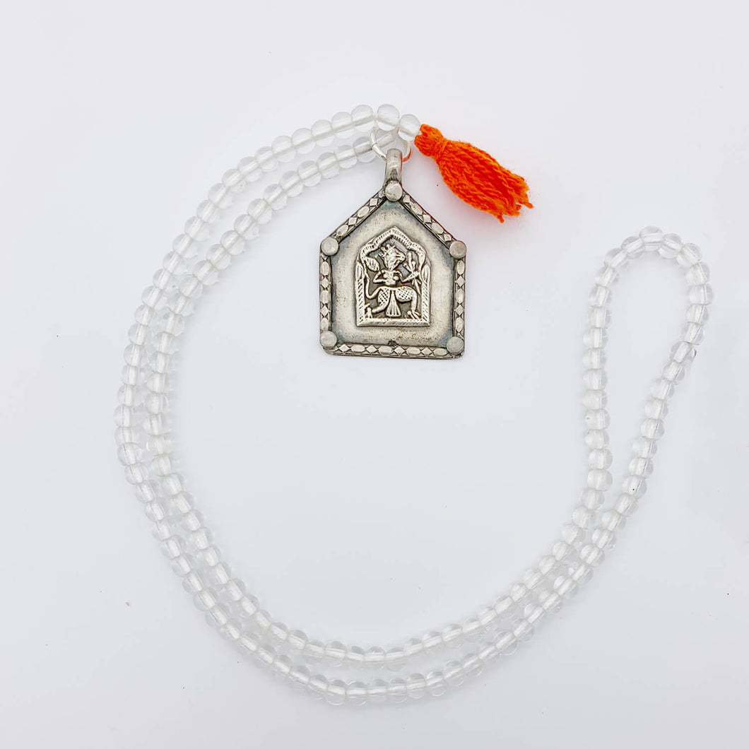 Clear Beaded Old Fashioned Online charm with red tassel and silver pendant charm on on flat lay