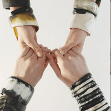 Load image into Gallery viewer, two people holding hands, wearing bold horn bangles
