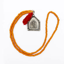 Load image into Gallery viewer, Orange Beaded Old Fashioned Online charm with red tassel and silver pendant charm on flat lay
