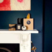 Load image into Gallery viewer, A picture of gifts and candles on a fire place mantle in a dark blue room
