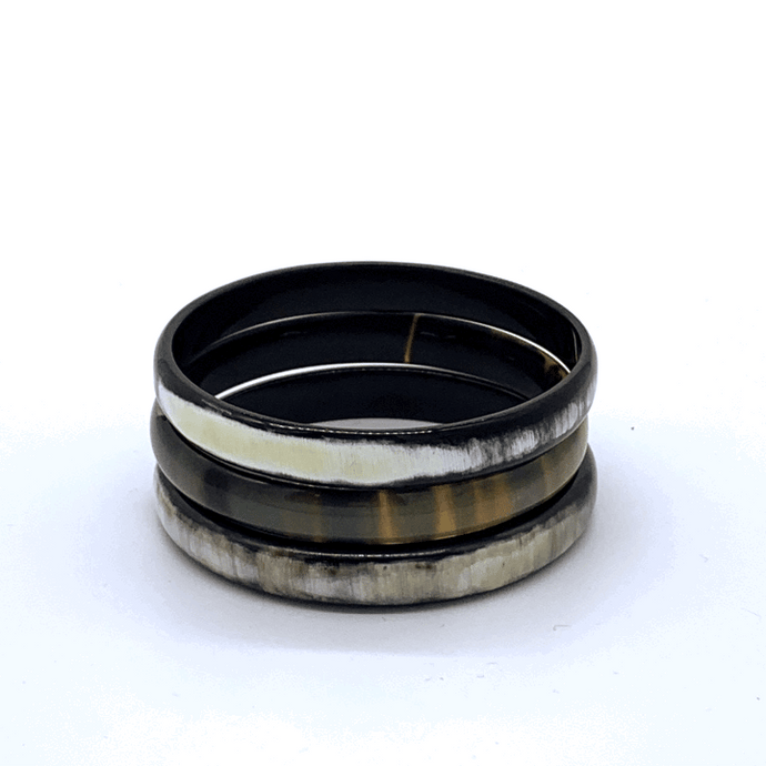 A picture of a spinning stack of 6 slender monochrome Old Fashioned Online bangle bracelet, ethically sourced natural buffalo horn
