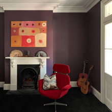 Load image into Gallery viewer, Red pink and orange painting in room with dark plum walls, an old fashioned Victorian fireplace and guitars 
