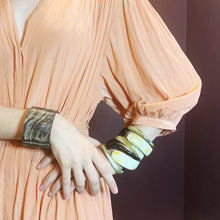 Load image into Gallery viewer, girl in peach dress wearing natural buffalo  horn bracelet  and several polished Horn bangles
