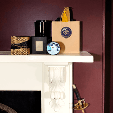 Load image into Gallery viewer, picture of candle and gifts on a fire place mantle in a burgundy room
